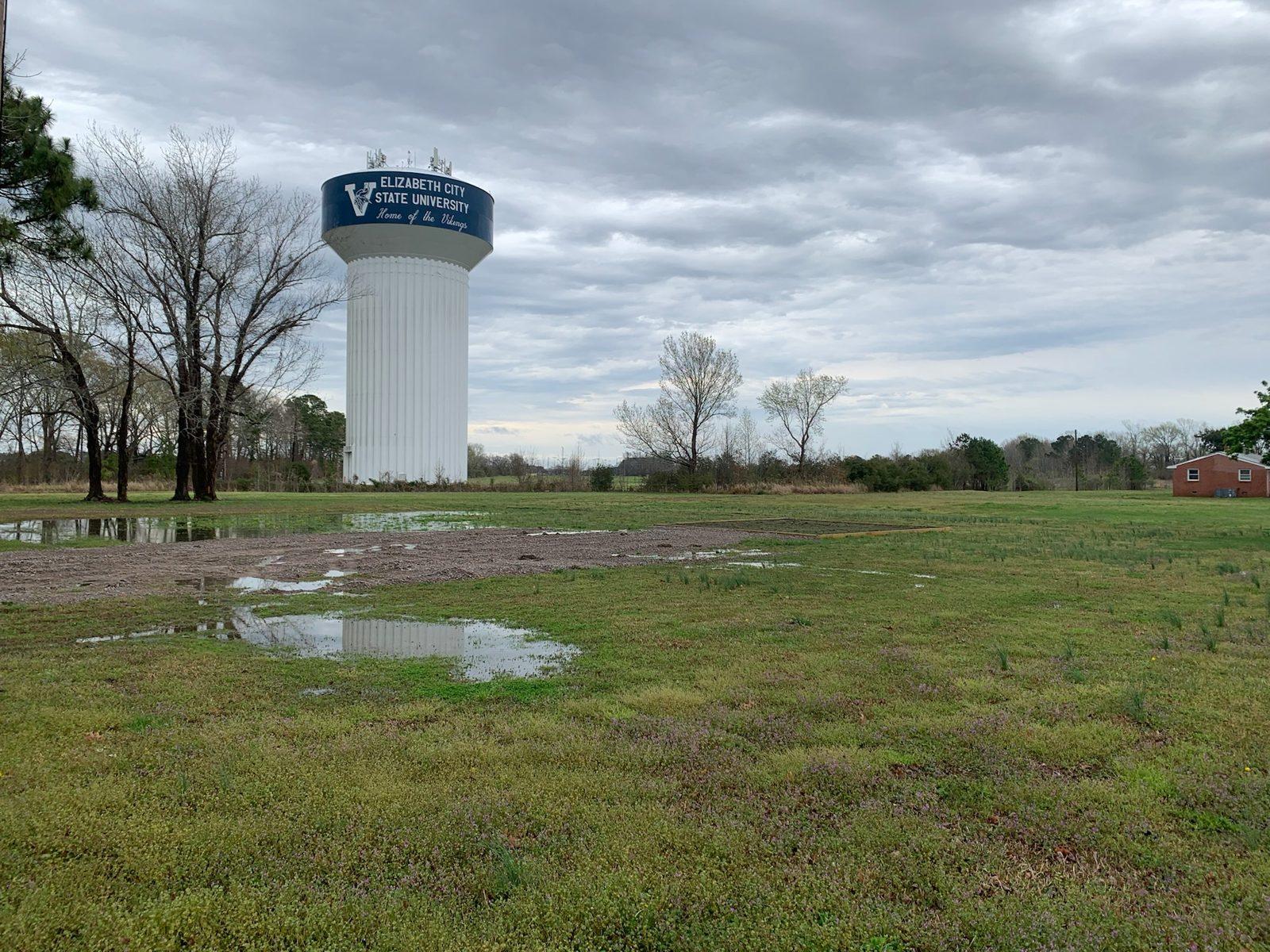 Before: The bare, waterlogged field beside the ECSU water tower at the March site visit. UAV Drone Enclosure Built for Elizabeth City State University