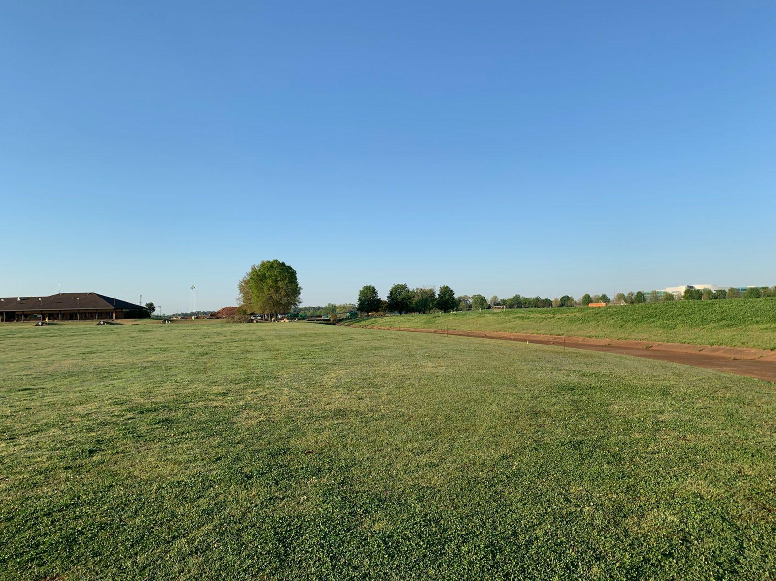Before: The open range edge along the drainage path before any poles went in. Driving Range Netting Installation at Madison Golf Center