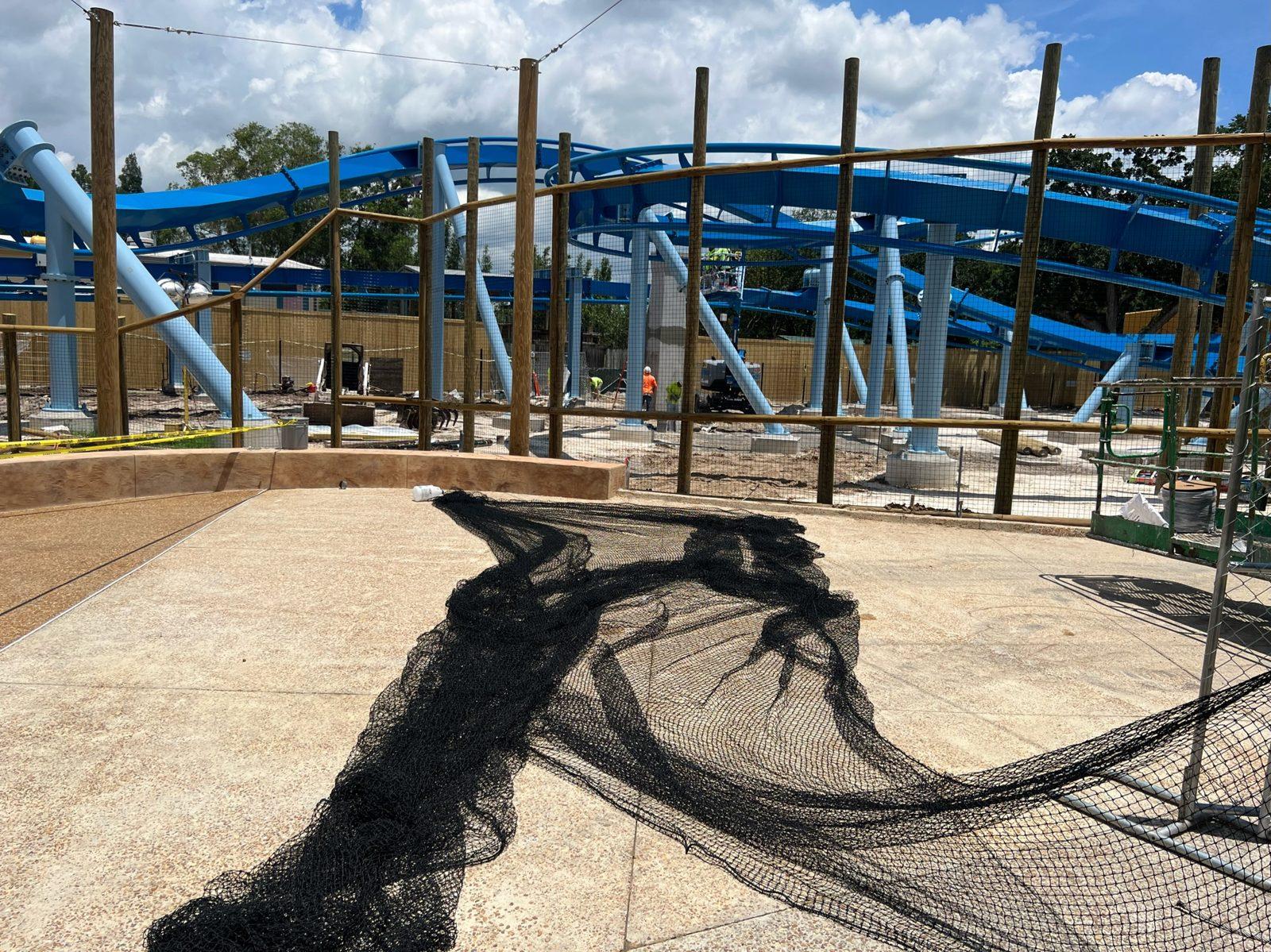 During: Net panel laid out on the plaza beside the new wood poles. Overhead Netting at Busch Gardens Tampa Bay