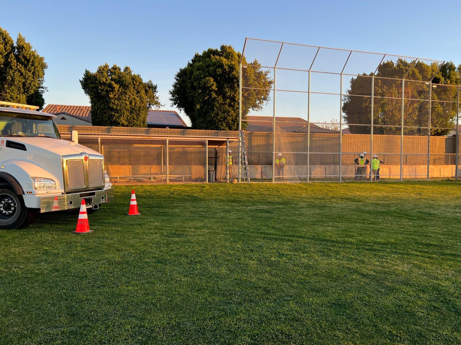 During: Crew prepping at the existing chain link backstop on day one. Baseball Backstop Netting at Millennium High School