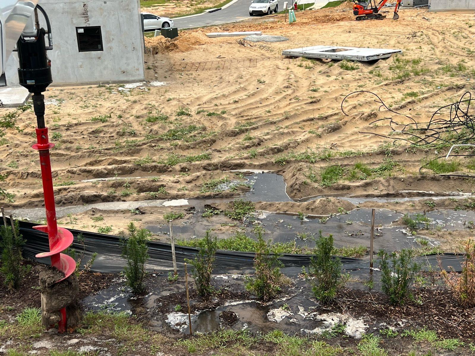During: Auger on site for digging the pole holes. Concrete Pole Setting at an ONX Homes Community