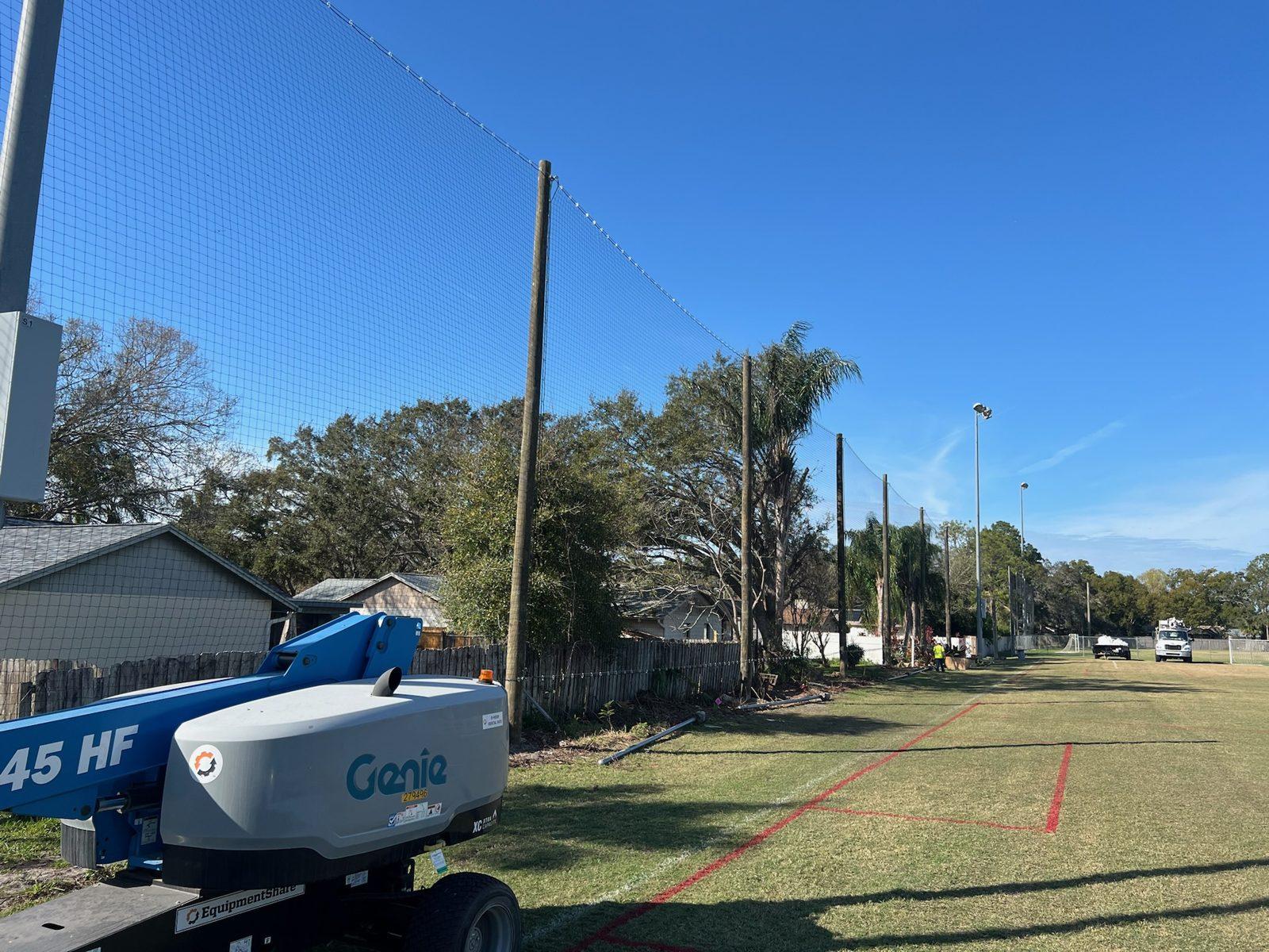 During: Black netting going up along the new wood pole line. Soccer and Volleyball Netting for Palm Harbor Parks & Recreation