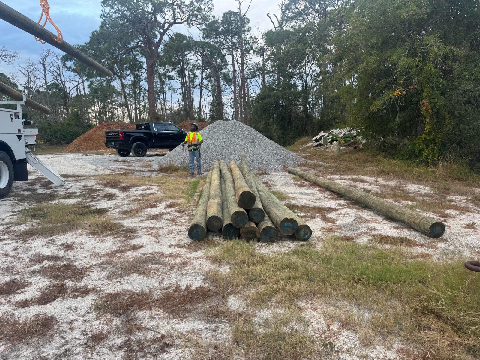 During: Wood poles and gravel staged at the first stop. Park Entrance Pole Setting Across Pinellas County
