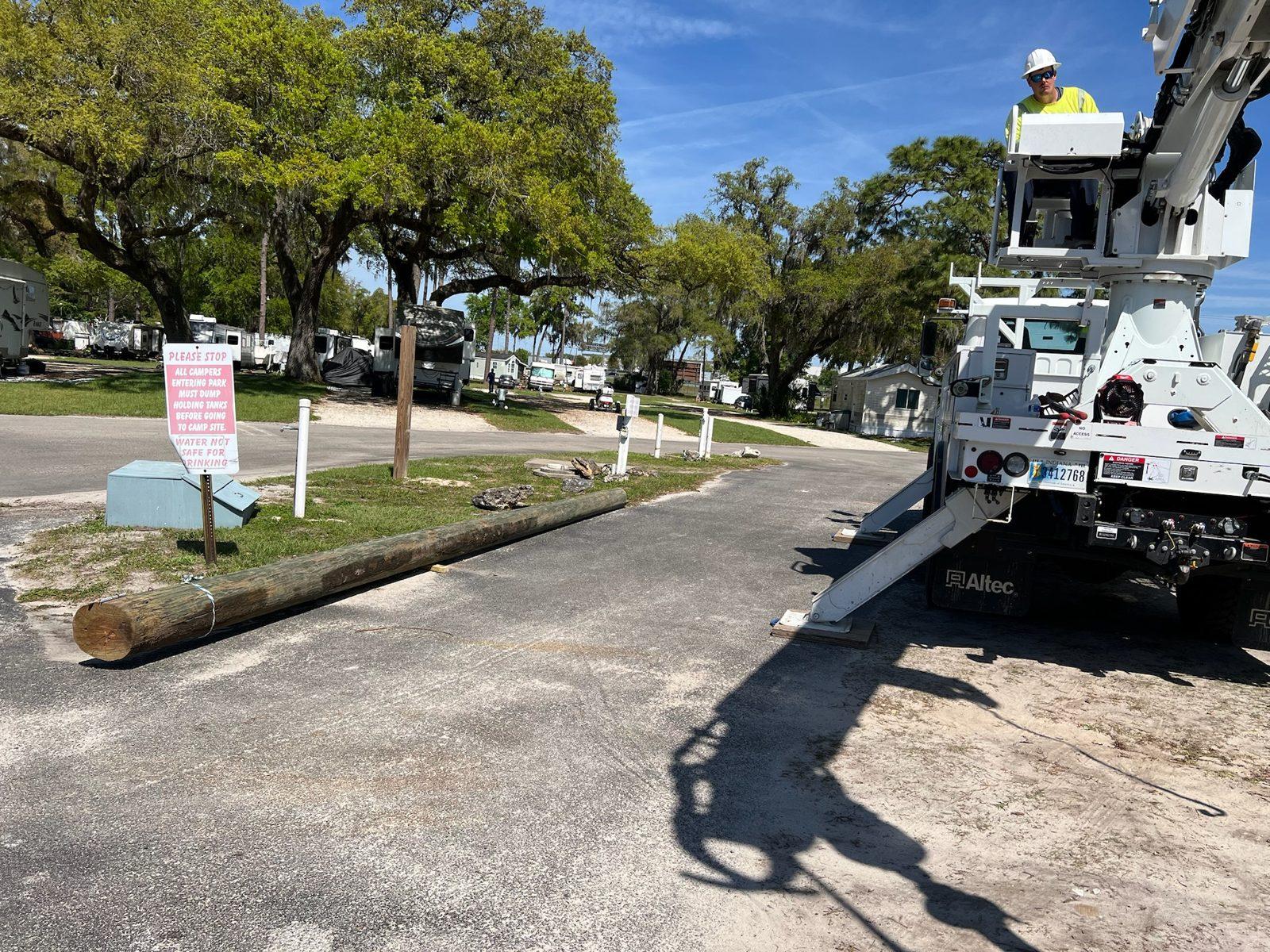 During: Pole staged on the ground at the park entrance. Wood Pole Setting at an RV Park in Central Florida