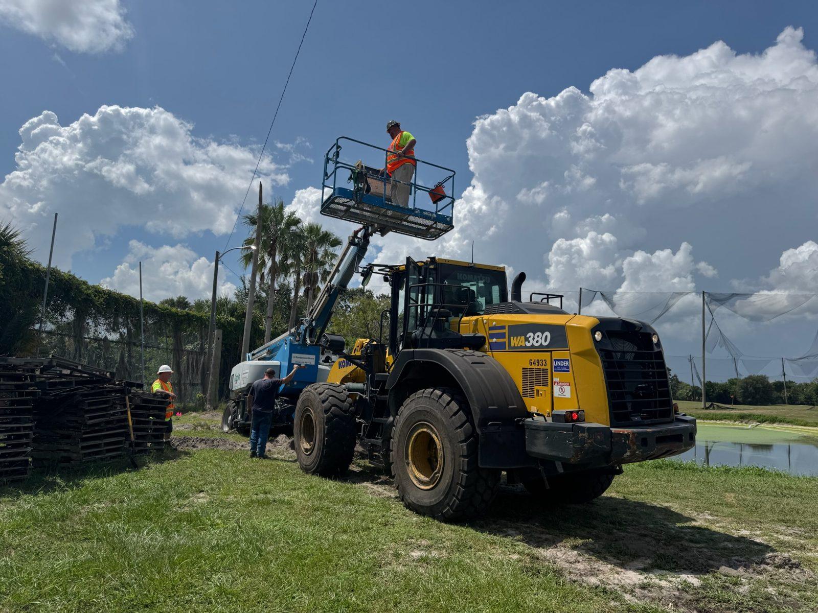 During: Lift and loader staged as removal begins. Perimeter Netting Replacement at the YMCA Par 3 Course in Lakeland