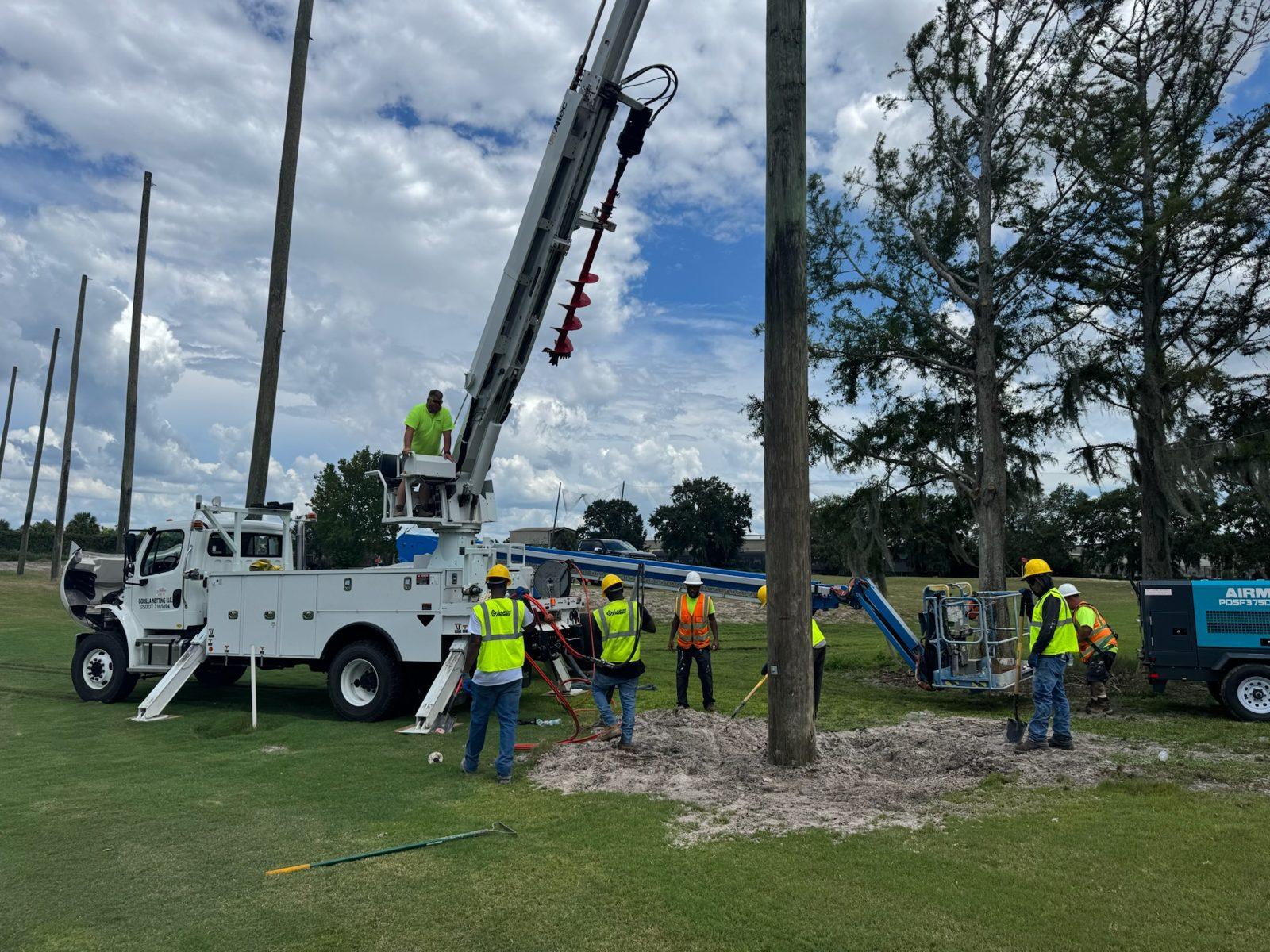 During: Auger truck and crew at a freshly set pole. Perimeter Netting Replacement at the YMCA Par 3 Course in Lakeland