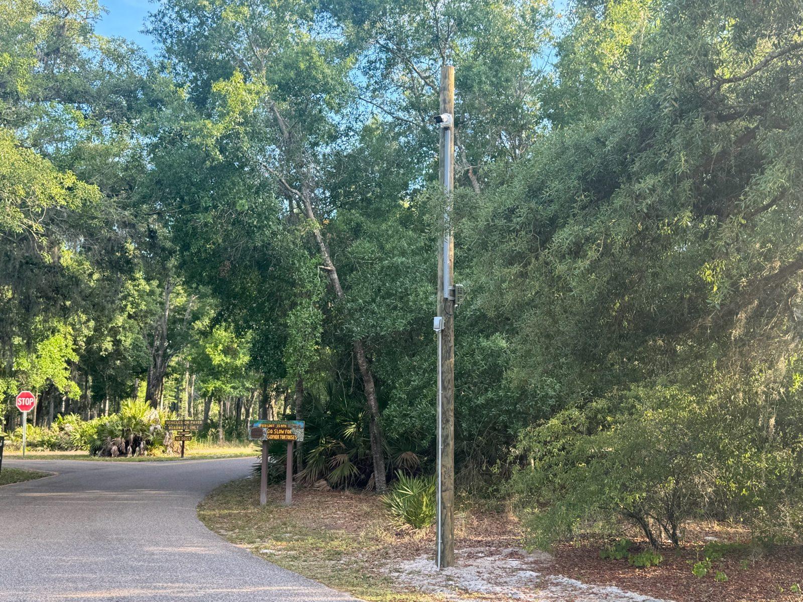 Before: Park gate and entrance sign before work. Park Entrance Pole Setting Across Pinellas County