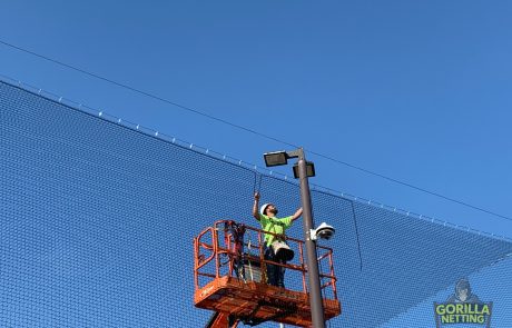 Gorilla Netting Crew Member Installing Rope on Overhead Netting & Backstop